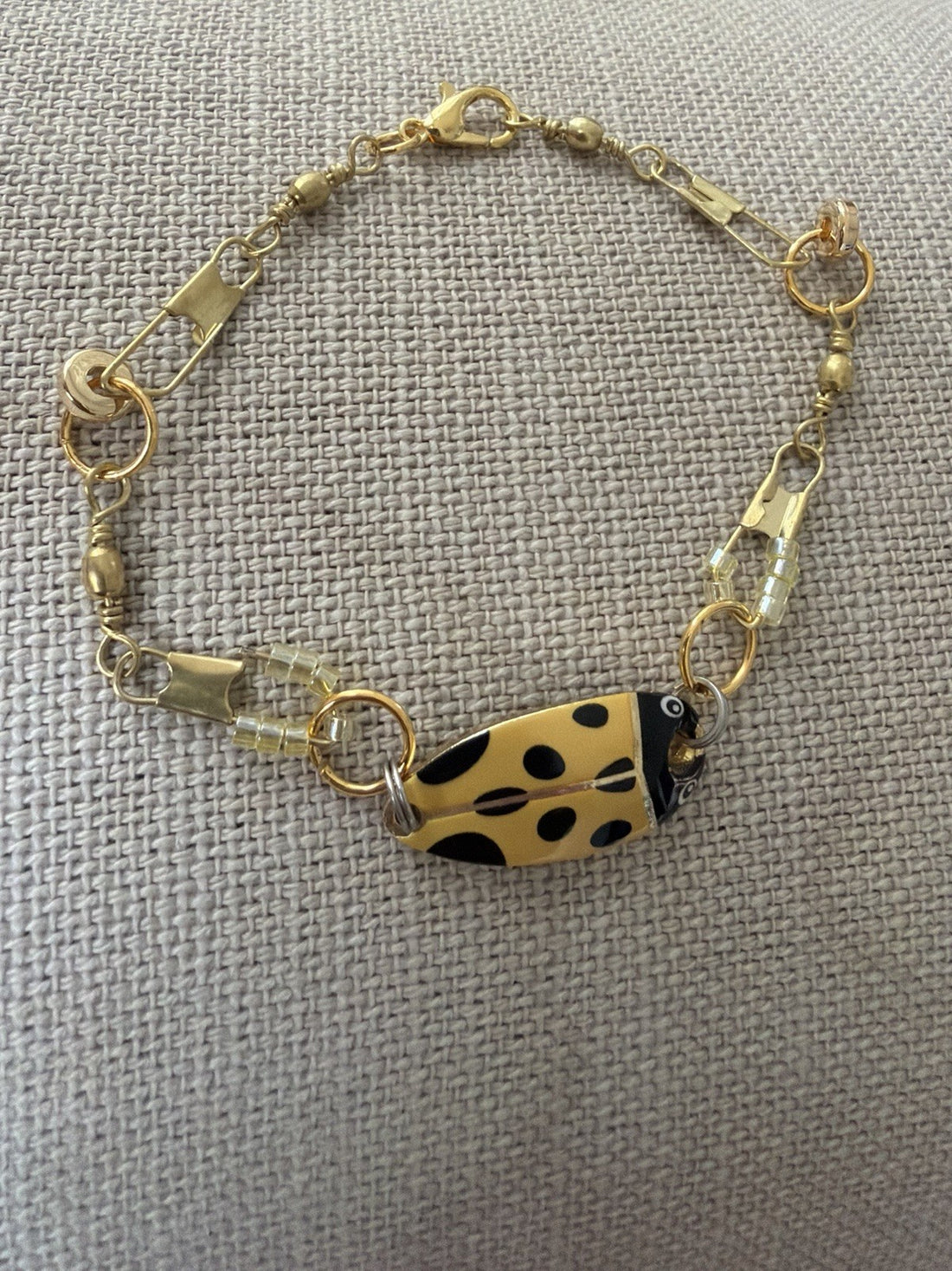 gold tone chain bracelet with fish charm