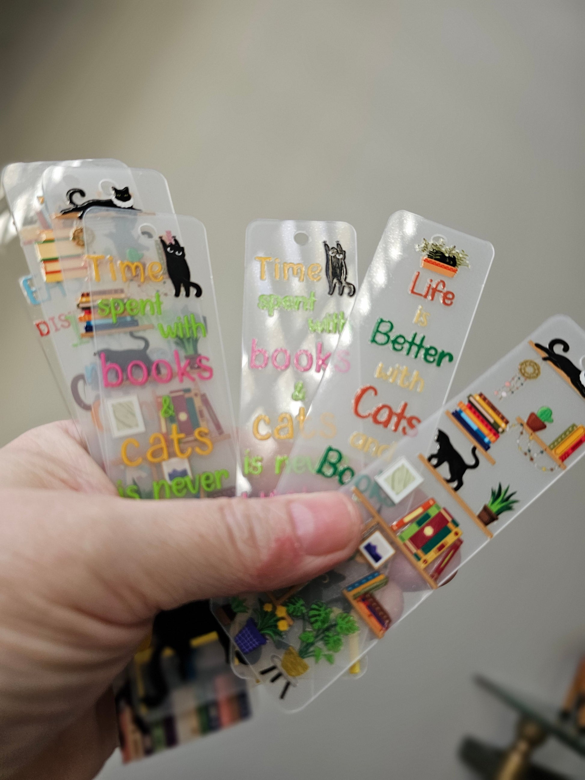 Bookshelf Bookmarks with black cats in hands