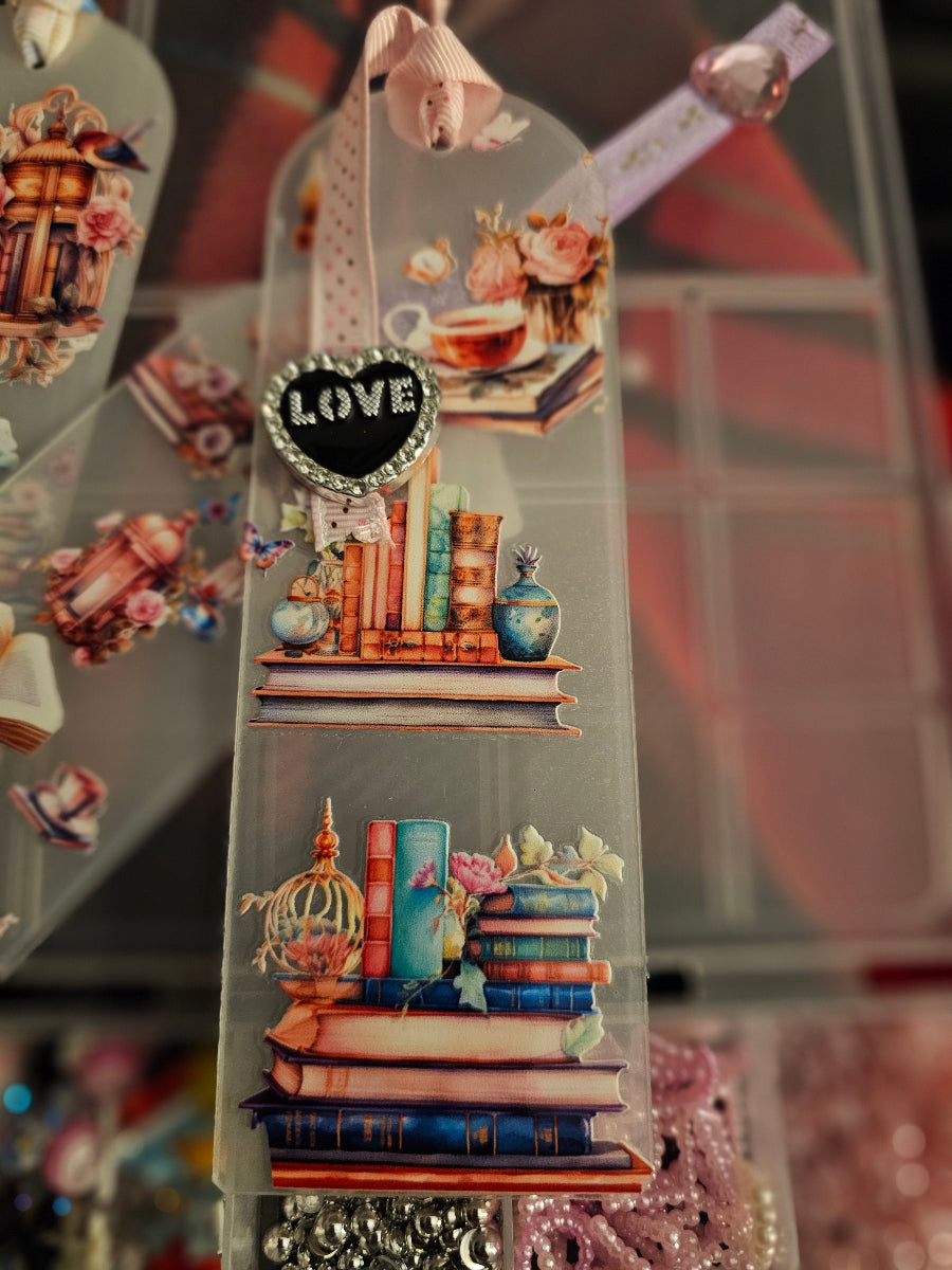 Decorative Handmade Unique Book Charm Bookmark with books and 'LOVE' heart charm on a blurred background