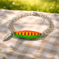 Bracelet with a colorful fishing lure charm on a checkered fabric background