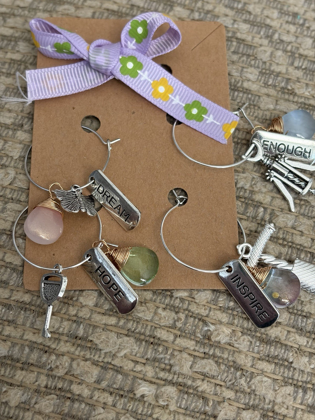 Handmade glass bottle charms featuring inspirational tags and colorful beads, perfect for wine glass accessories.