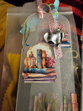 Decorative Handmade Unique Book Charm Bookmark with heart charm and book illustration on a clear background