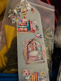 Decorative Handmade Unique Book Charm Bookmark  with illustrations of books and a bow on a clear background