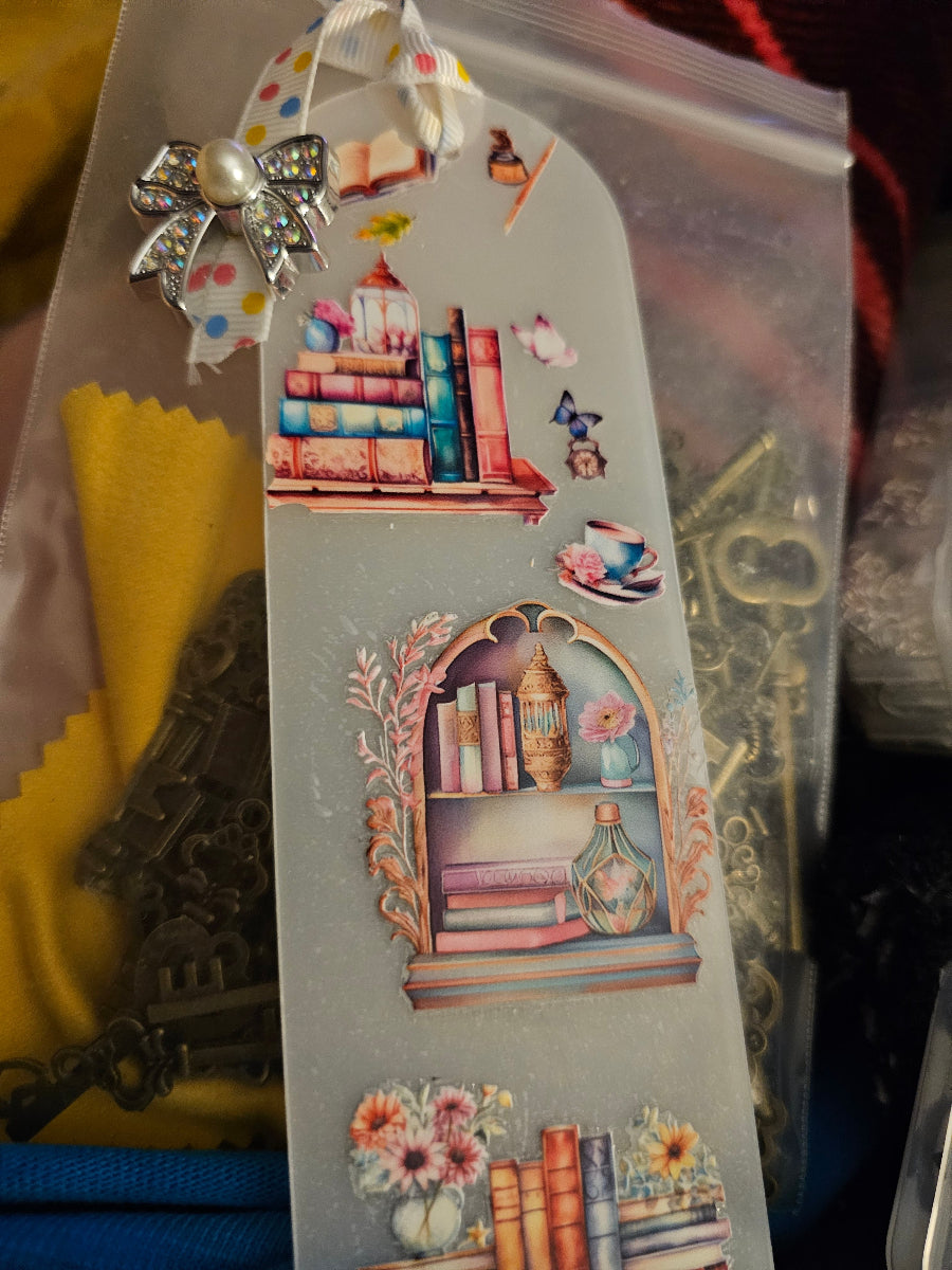 Decorative Handmade Unique Book Charm Bookmark  with illustrations of books and a bow on a clear background