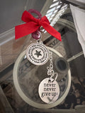 Bracelet with charms and a red ribbon on a blurred background