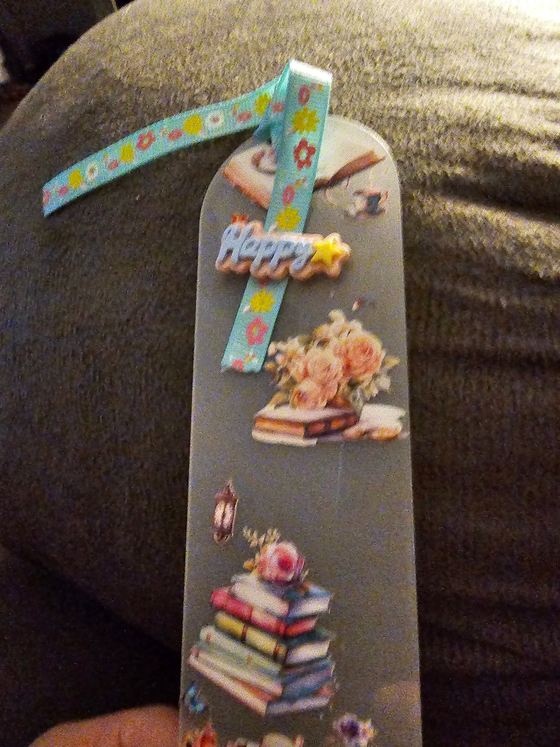 Decorative Handmade Unique Book Charm Bookmark  with colorful ribbon and illustrations on a textured surface