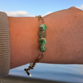 African Turquoise Glass Bead Bracelet worn on wrist, showcasing serene colors resembling calm waters.